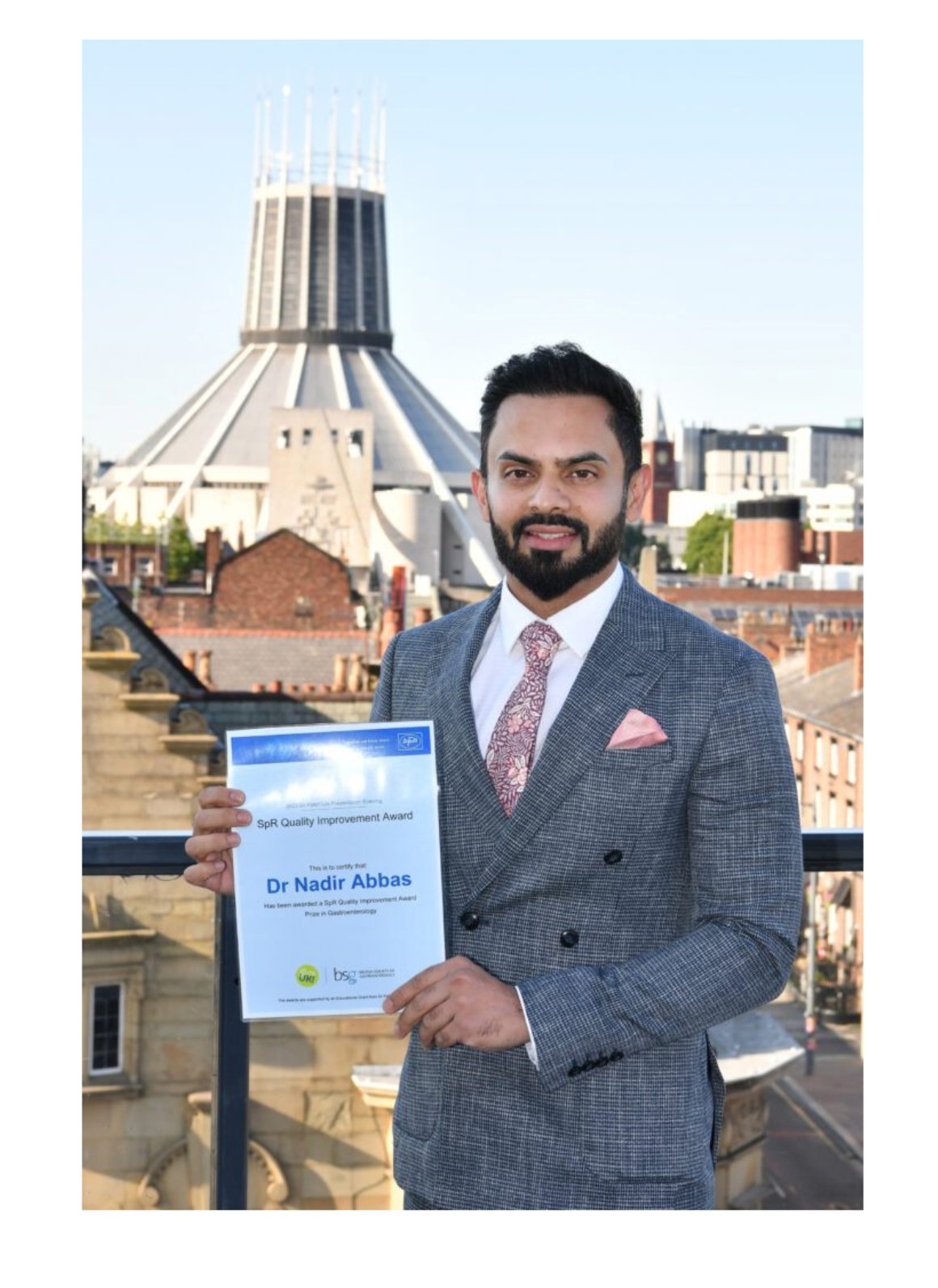 Dr Nadir Abbas holding the award