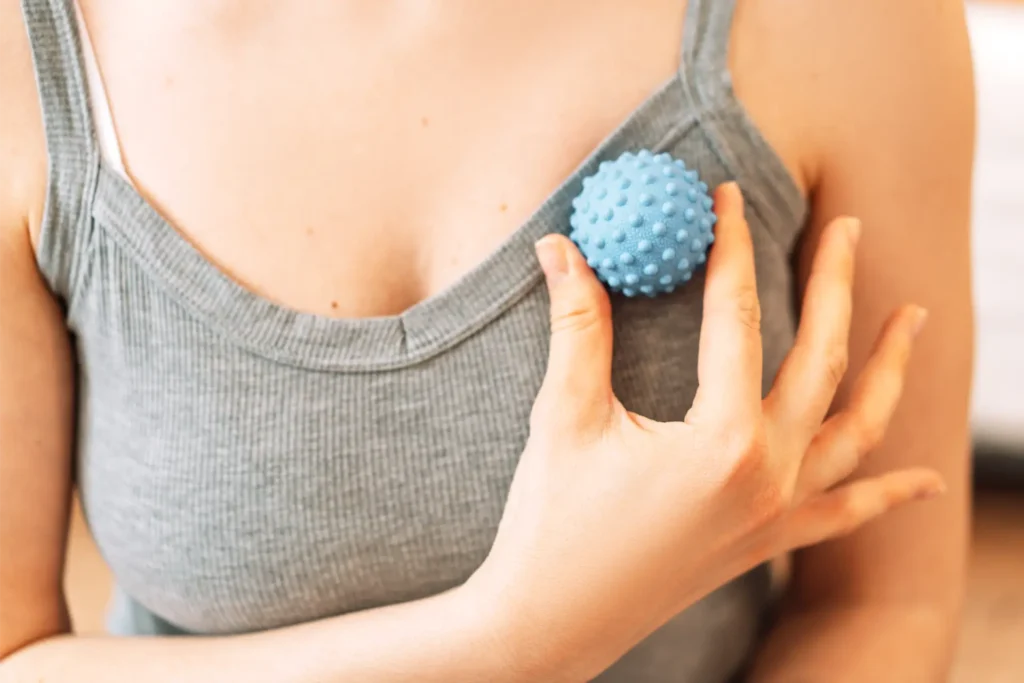 lady kneads pectoral muscles with myofascial ball 2025 02 12 05 55 08 utc